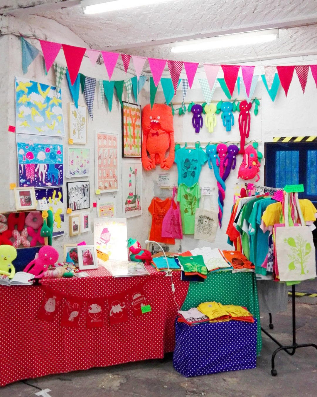 人形やアート作品、Tシャツなどが並ぶ展示風景